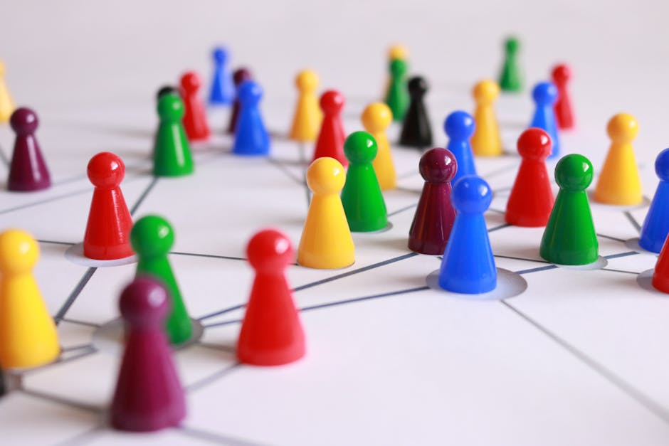 A strategic arrangement of colorful pawns connected on a game board, symbolizing networking and teamwork